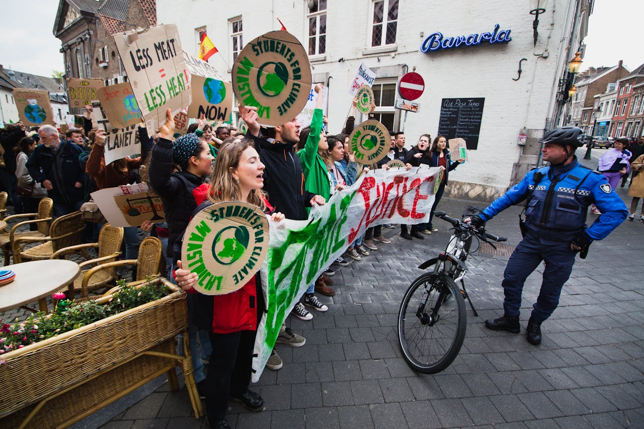 services-03 Protesters rally in Maastricht advocating for climate action and environmental justice.